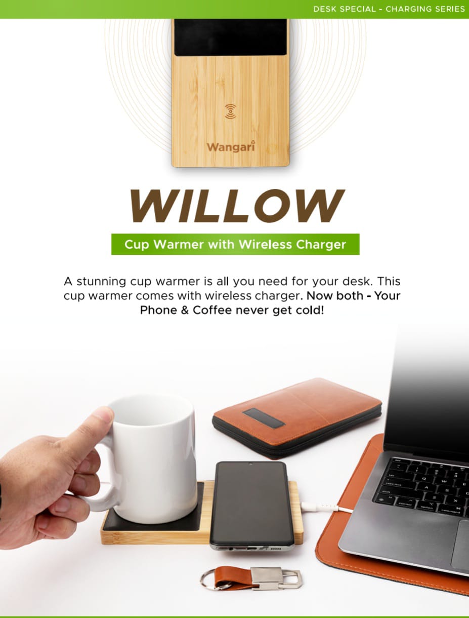 Wangari - Willow Cup Warmer with Wireless Charger in bamboo finish, keeping a coffee mug warm while wirelessly charging a smartphone on a modern office desk setup with laptop and leather accessories